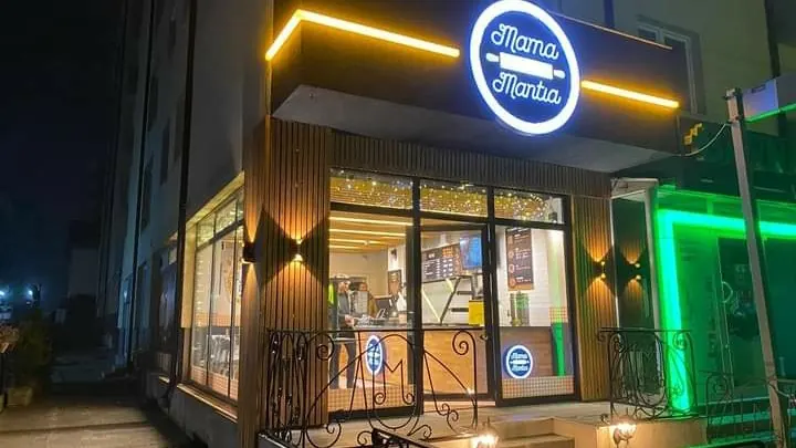 The shop front lit up at night