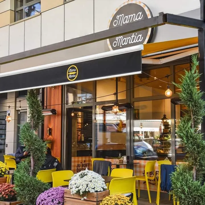 Mama Mantia's terrace with yellow chairs on Rruga Bajram Kelmendi